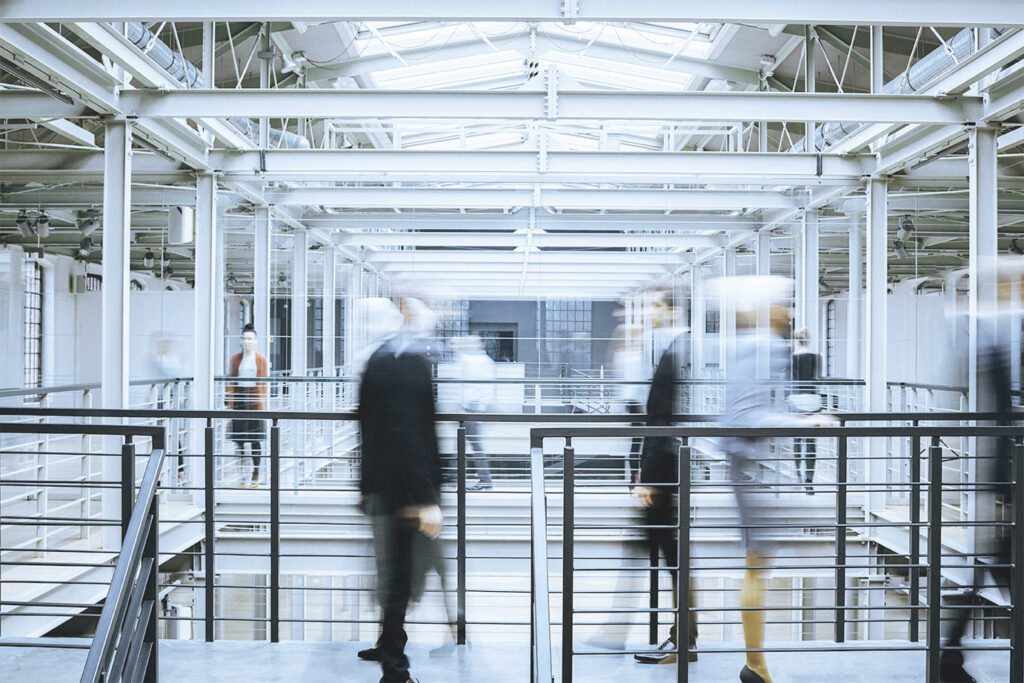 Blurred business people walking in modern office